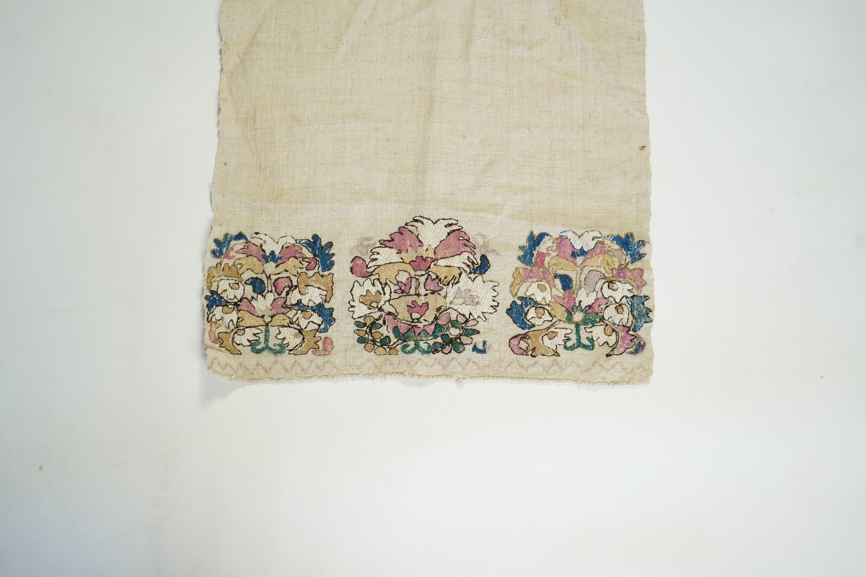 An early 20th century heavy hand woven linen Turkish towel, with coloured silk embroidered ends. 123cm long x 43cm wide. Condition - has two stains and some embroidery worn in places.